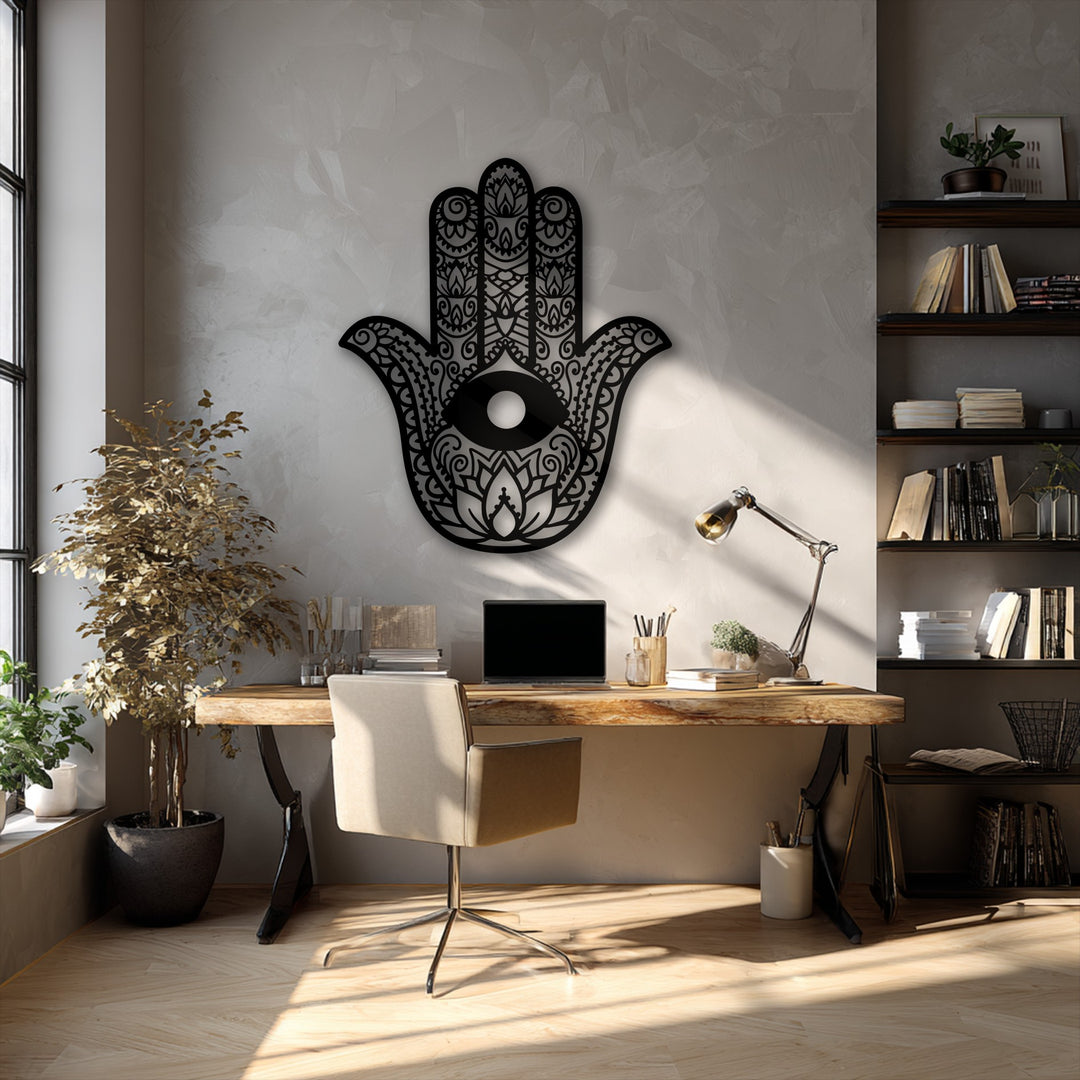 The stark color contrast of the black Hamsa Hand metal art for wall against the bright, textured wall highlights its intricate Evil Eye design.