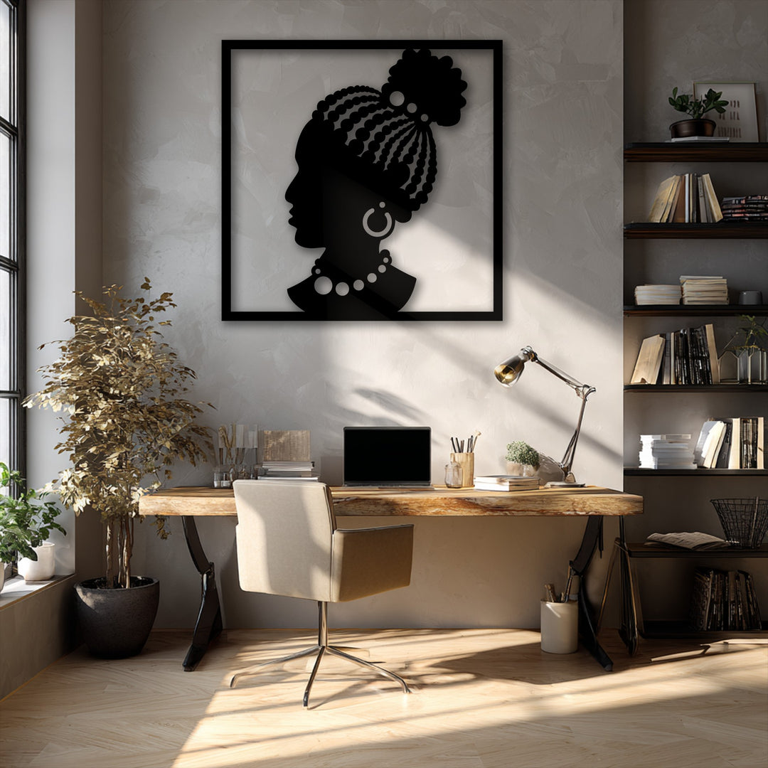 The elegant African Woman Silhouette metal artwork stands out, demonstrating a rich transition from its deep black to the wall's textured, sun-dappled beige.
