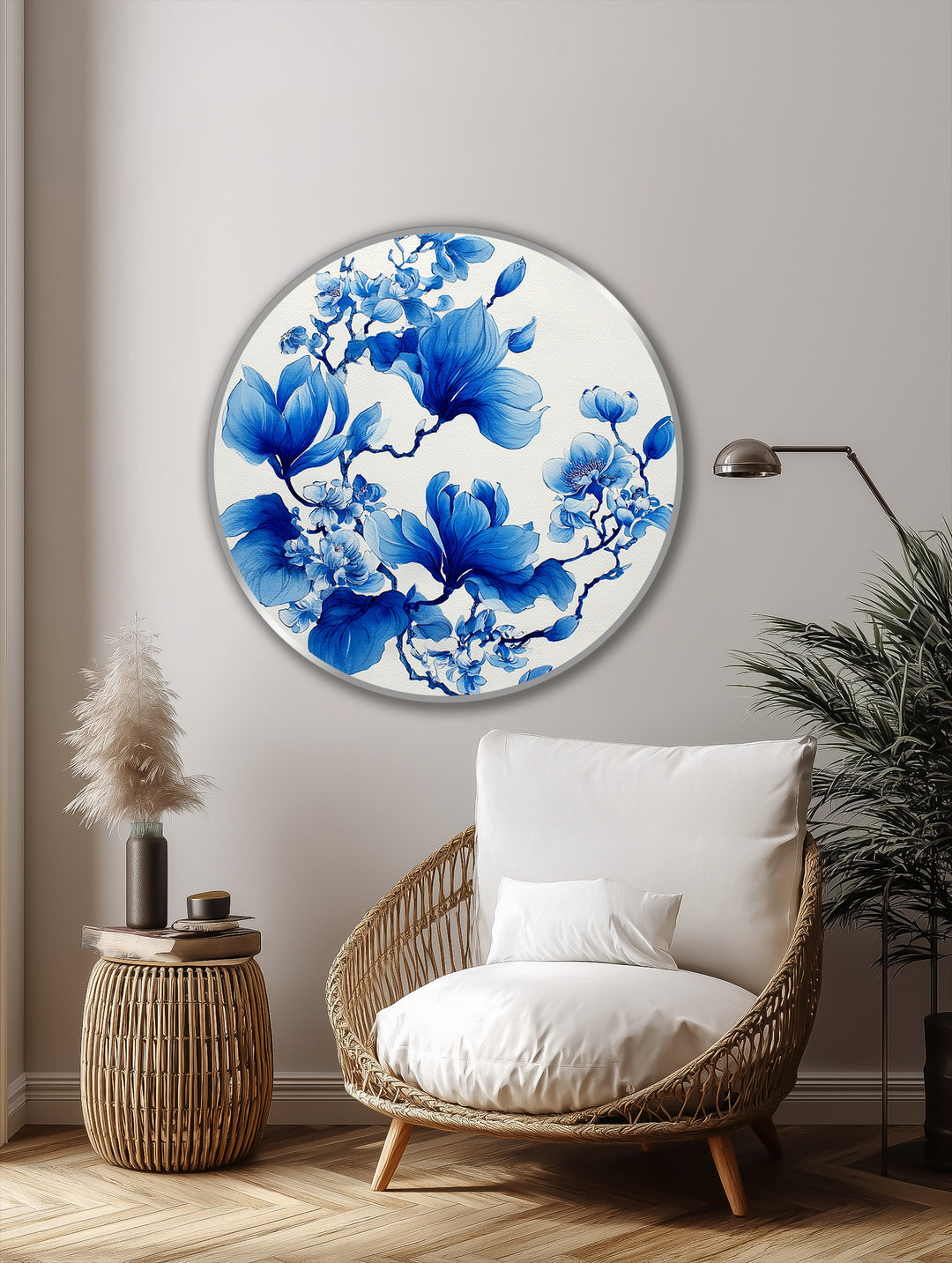 Foreground shows a comfortable wicker chair and side table with a delicate oil painting home decor featuring elegant blue magnolia blossoms on a round canvas.