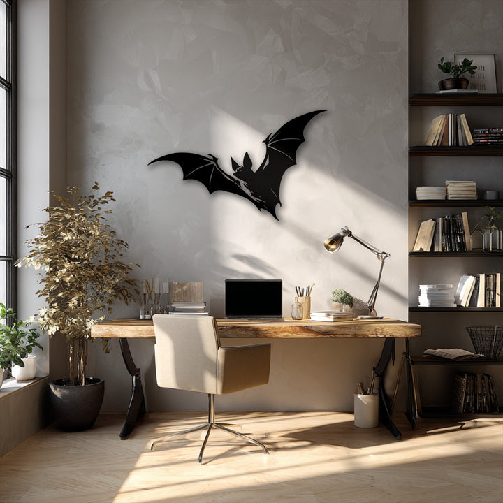 The textured wall showcases a striking flying bat silhouette metal artwork, complemented by the rustic surface of the wooden desk.