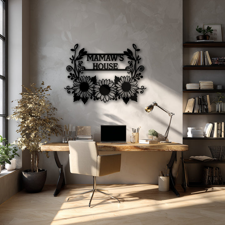 The loudest element is the personalized sunflower family name metal decoration wall art, reading 'MAMAW'S HOUSE,' prominently displayed on a light gray wall.