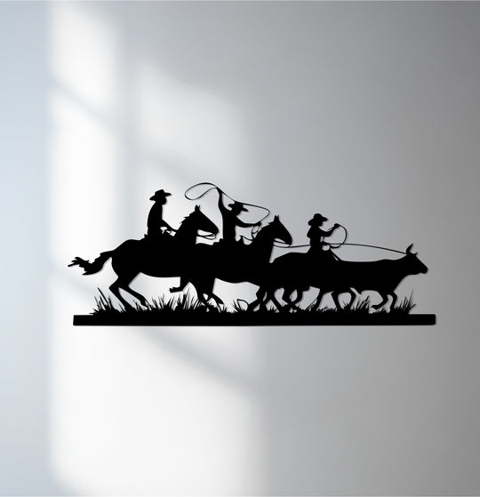 Monochromatic color saturation enhances the dramatic silhouette of this decorative metal art depicting cowboys and horses in a Western rodeo scene.