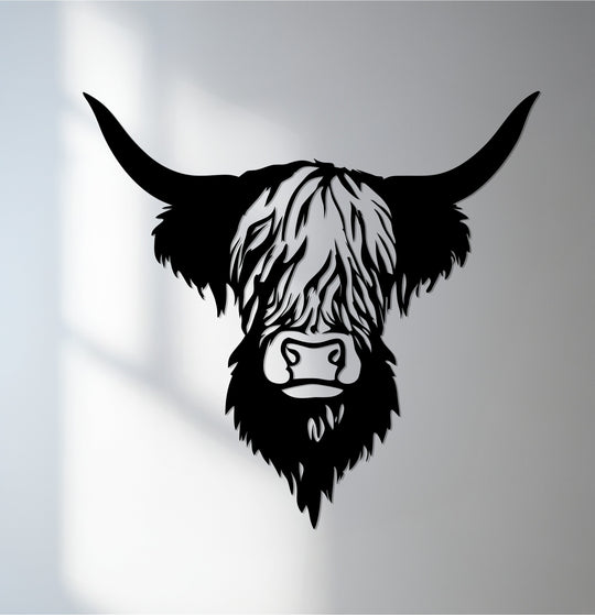 Limited color saturation in this metal artwork of a highland cow creates a striking, monochromatic effect in this rustic farmhouse red bull decor.
