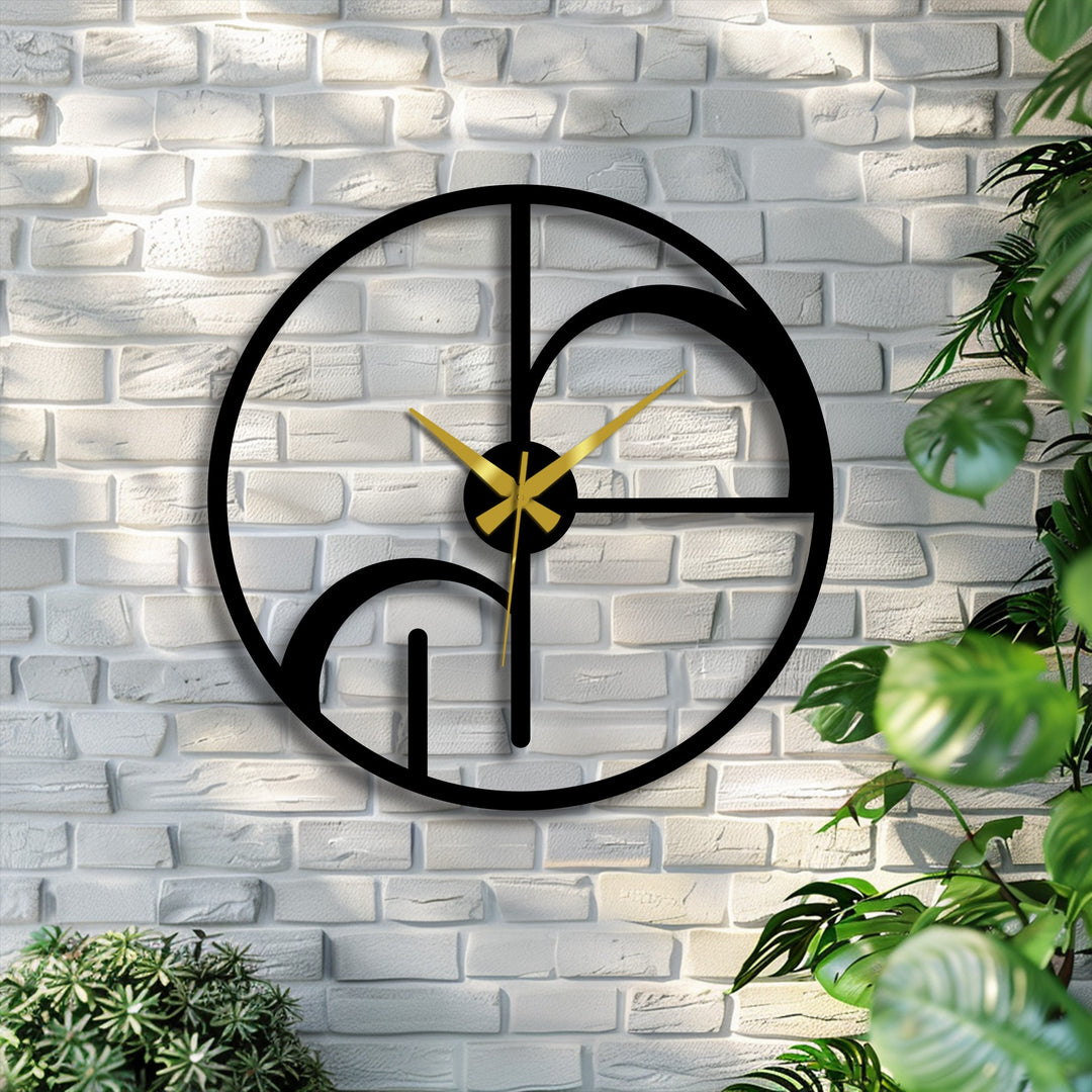 Horizontally oriented, the round metal artwork wall clock features an abstract geometric design, with gold hands creating a striking silhouette on a brick wall.