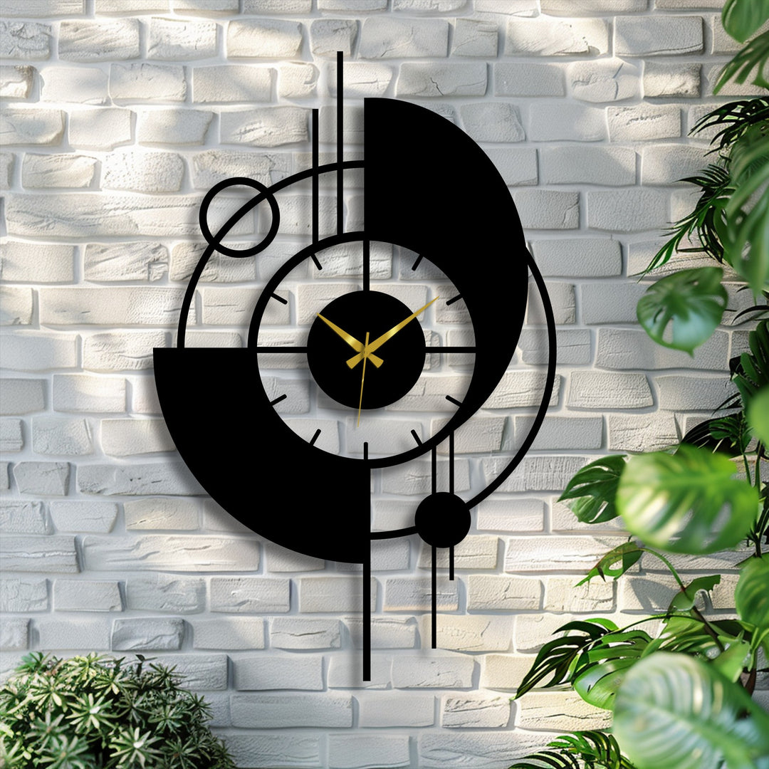 Green foliage highlights the sleek, abstract design of this modern orbit metal artwork wall clock, creating a striking visual contrast.