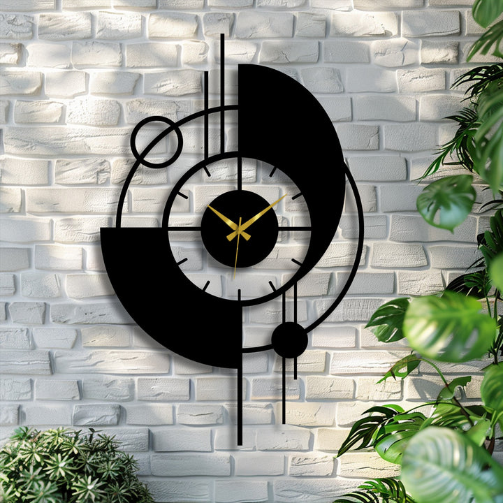 Green foliage highlights the sleek, abstract design of this modern orbit metal artwork wall clock, creating a striking visual contrast.