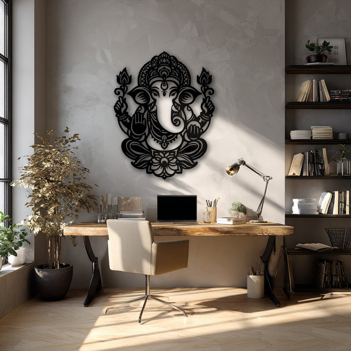 Subtle color transitions on the textured gray wall accentuate the deep black Ganesha decorative metal art under shifting sunlight.