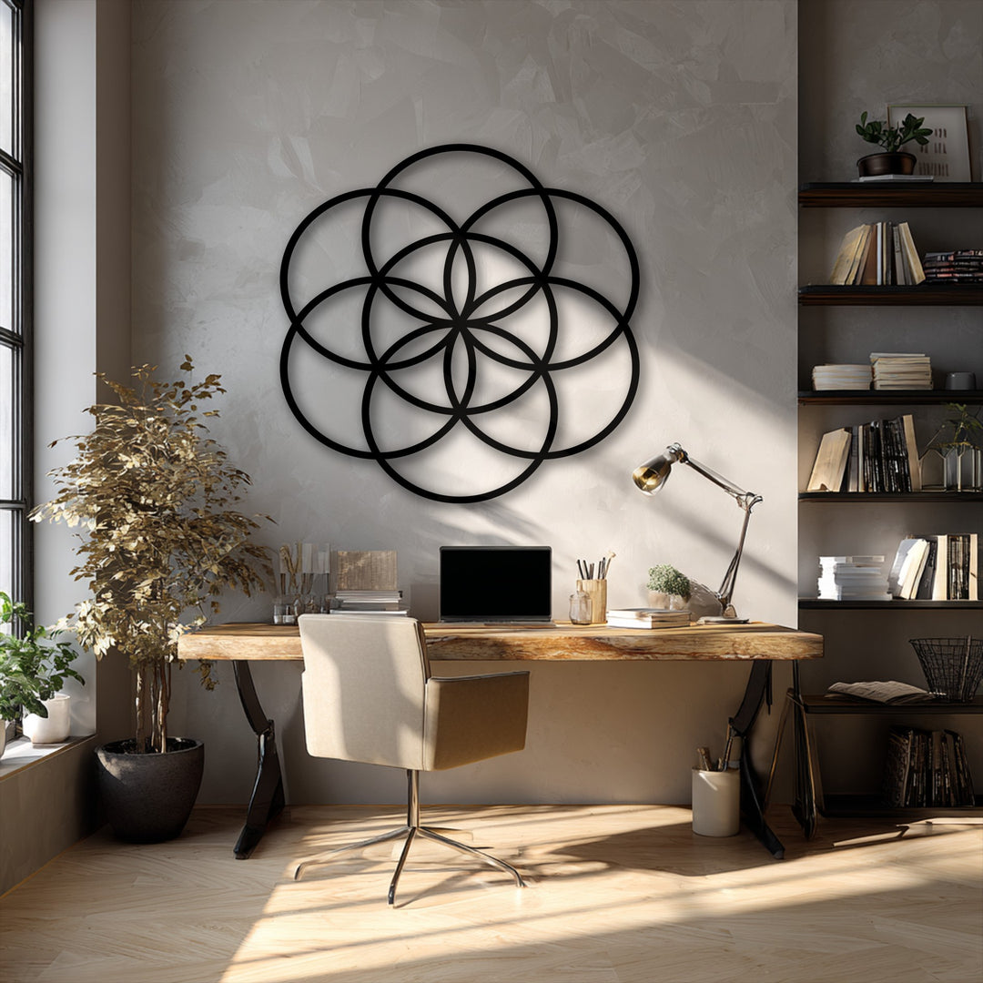The sharp, clean edges and intricate borders of the geometric Flower of Life metal artwork cast a captivating shadow against the wall.