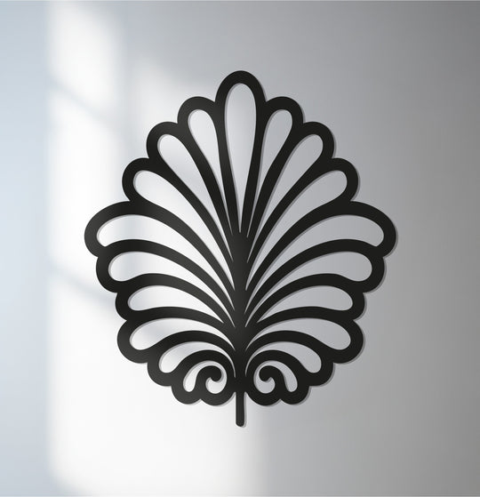 Bold color contrast highlights the design of this botanical leaf metal wall decor in black, creating a striking modern metal wall art sculpture.