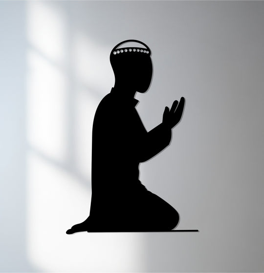 The stillness of prayer is captured in this silhouette depicting Islamic devotion, crafted as minimalist metal artwork for spiritual home decor.