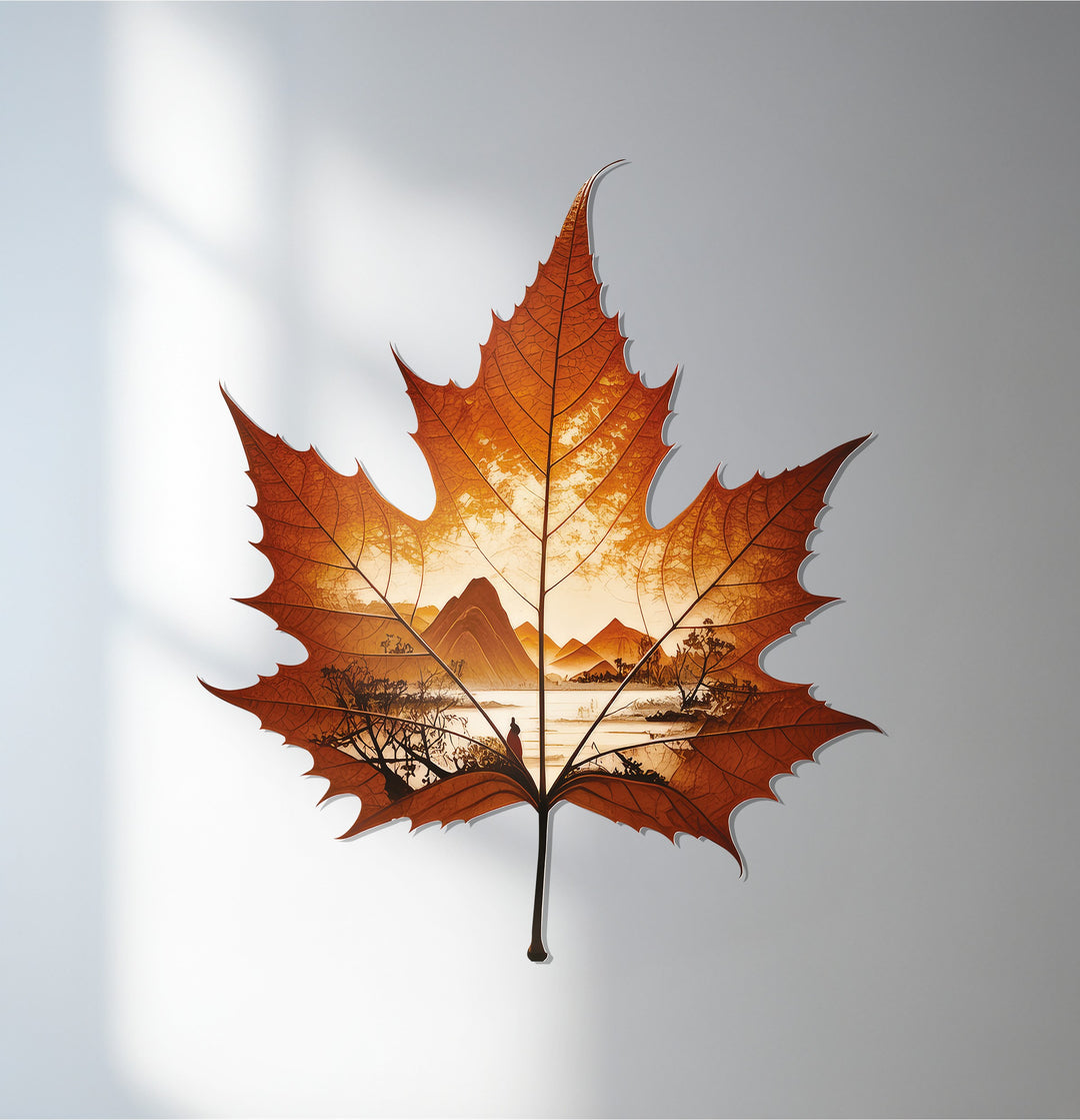 Vertically oriented maple leaf-shaped metal wall decor showcases an intricate autumn horizon landscape, adding a unique touch to any space.