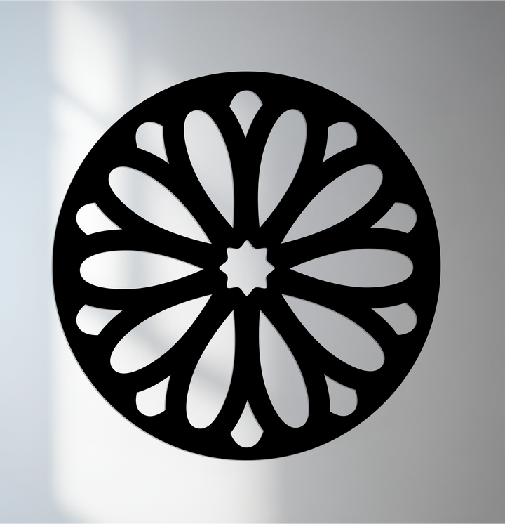 The organic forms of the minimal floral burst design highlight the artistry in this round black metal artwork wall art, creating a striking focal point.