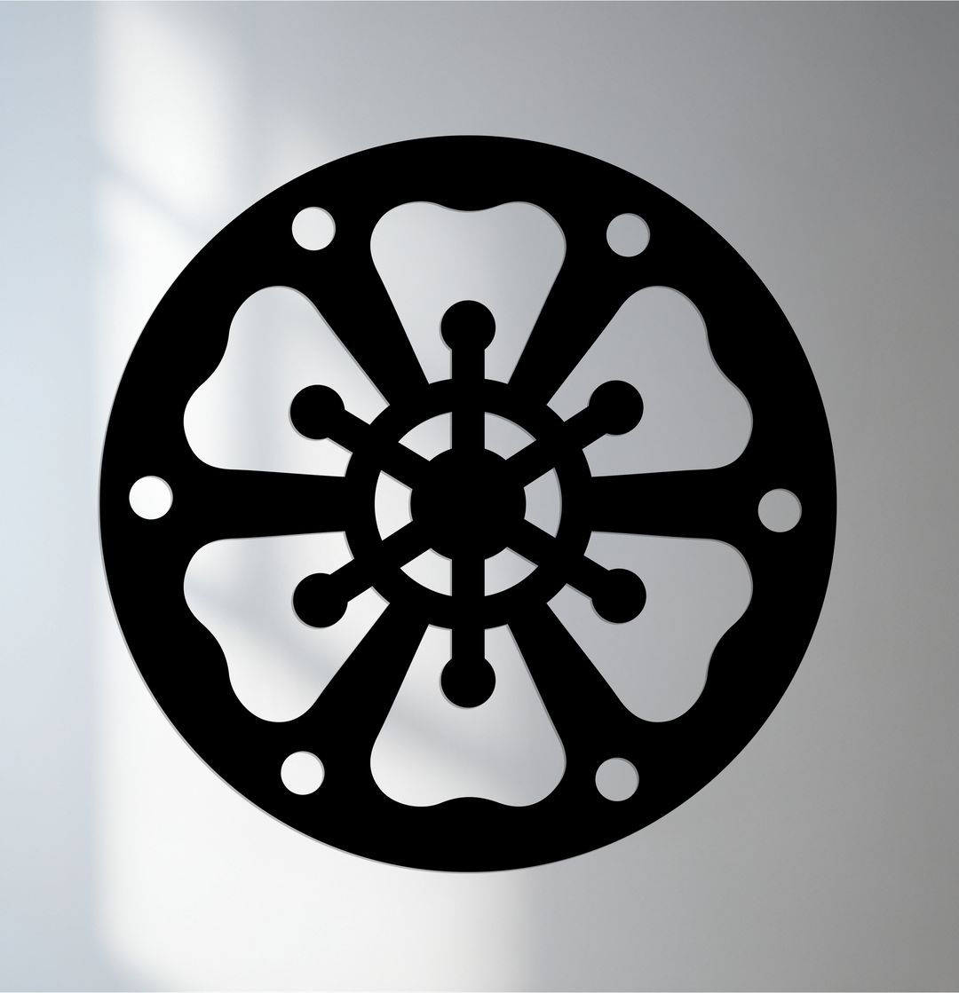 High color contrast defines this abstract wheel pattern in round black metal decoration wall art, creating a striking visual impact.
