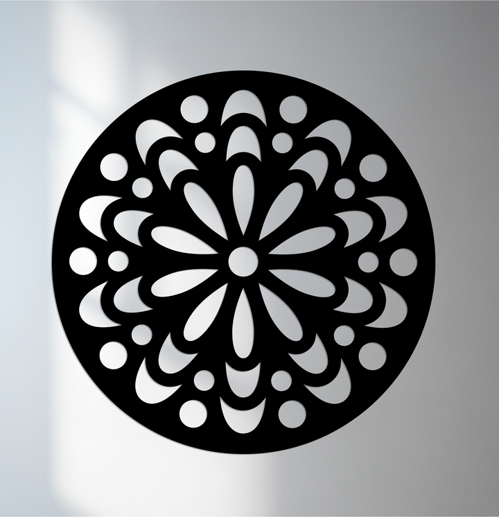 Intricate surface texture is evident in this ornamental floral mandala round black decorative metal art, a complex pattern cut out from a solid metal disc.