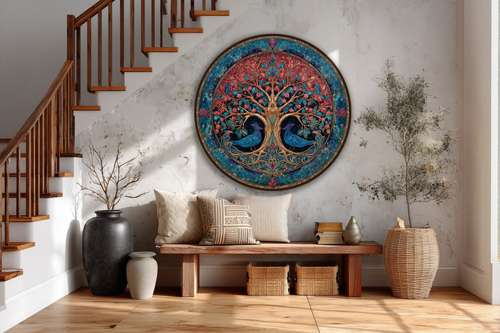 Warm and cool color contrasts define this round oil painting, a piece of modern oil painting art depicting an ornate tree of life with red blossoms and blue birds.
