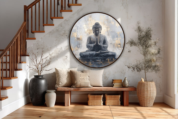 Featuring a textured finish, this round Sacred Serenity oil painting artwork showcases a meditating Buddha with shimmering gold accents.