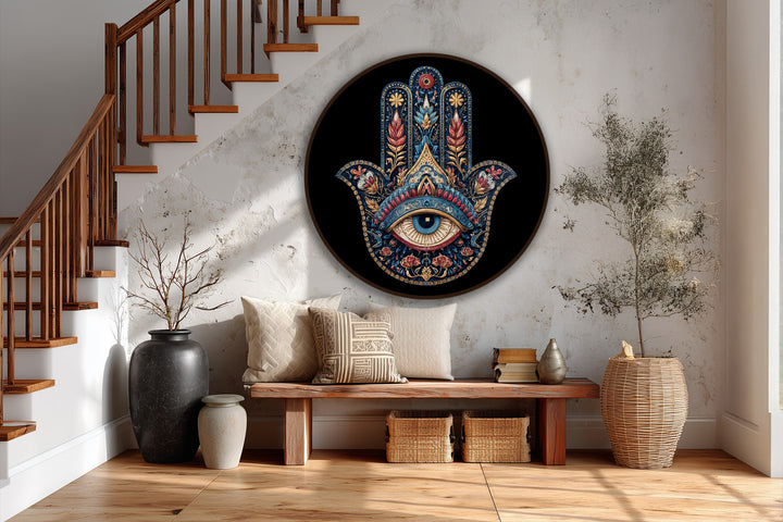 Foreground shows a handcrafted wooden bench topped with neutral cushions, accenting the ornate Hamsa hand with protective eye round oil painting wall art.