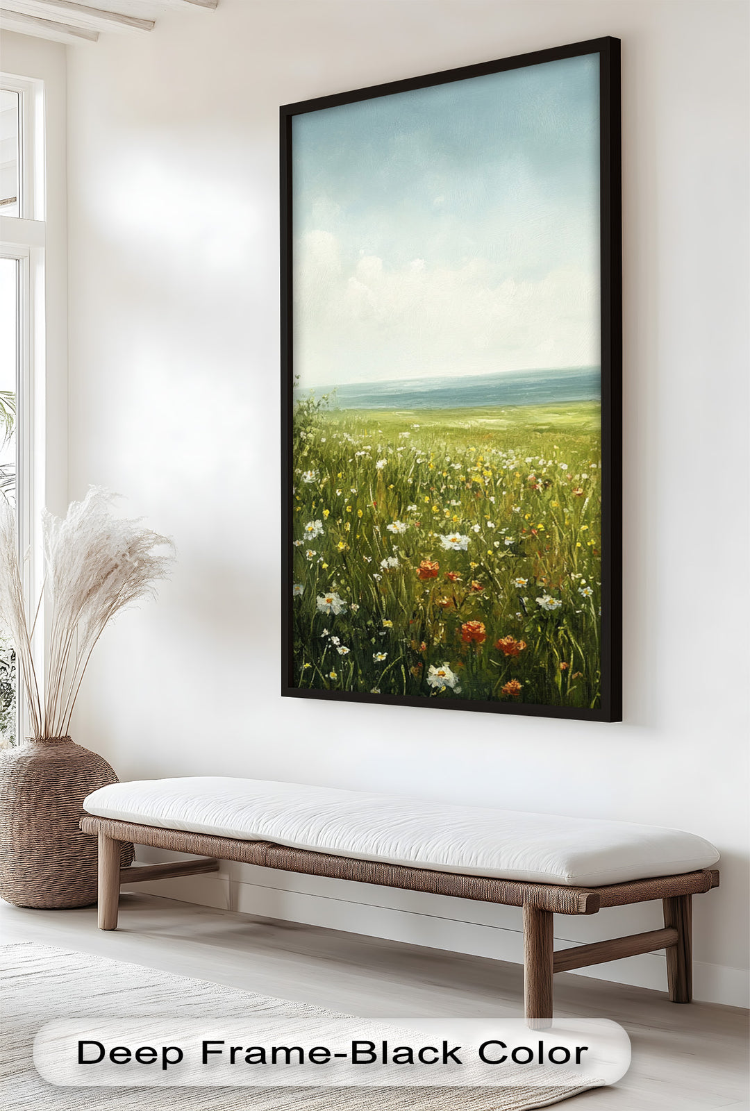 This serene landscape painting captures a sunlit wildflower meadow stretching toward the calm sea under a soft blue sky.