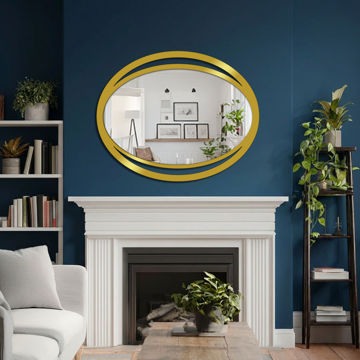 Gleaming gold modern mirror dominates above a fireplace, its double eclipse oval frame a striking and sleek visual focal point.
