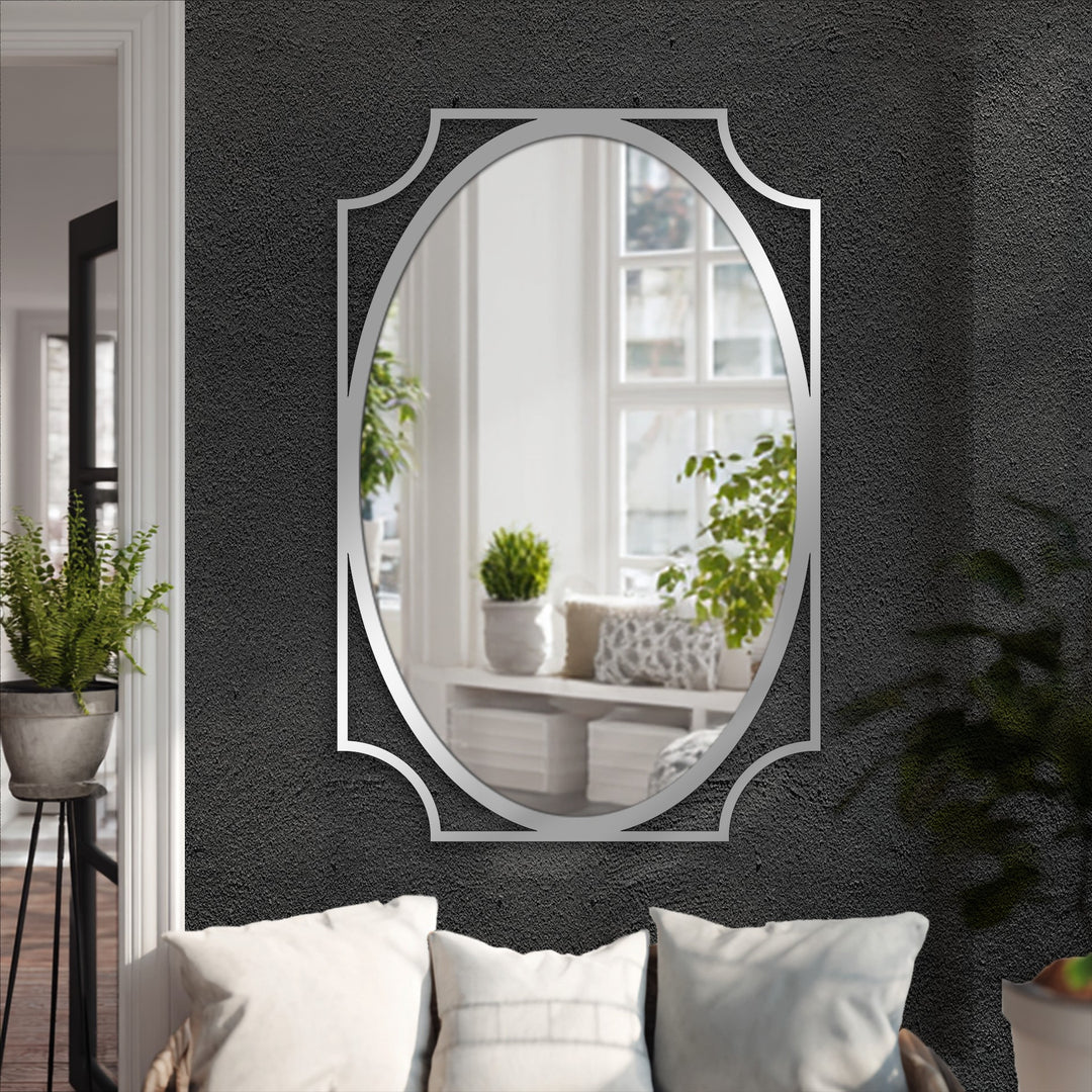 Highlighting the sleek silver frame, this oval floor mirror is a minimalist bathroom mirror that stands out with its curved corners and reflective elegance.