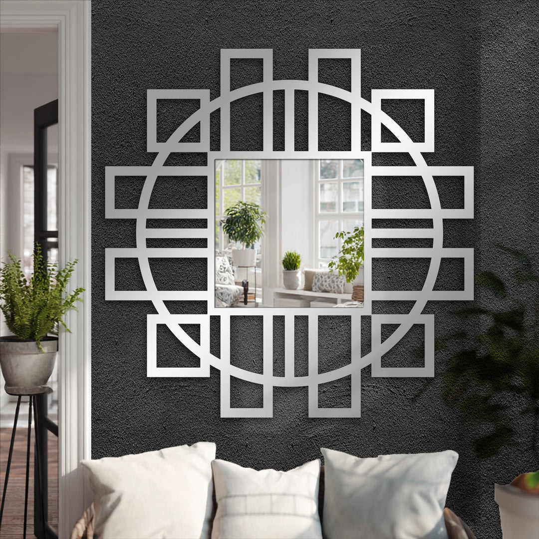 Negative space highlights the metal artwork of a modern geometric mirror, featuring a fusion of circular and square frame accents.