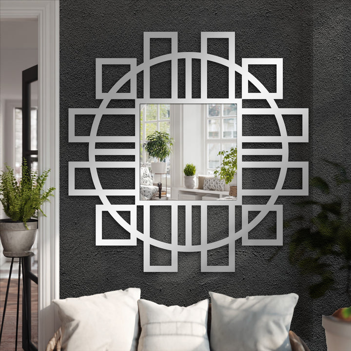 Negative space highlights the metal artwork of a modern geometric mirror, featuring a fusion of circular and square frame accents.