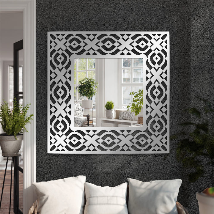 High color contrast highlights the geometric metal art for wall in the tribal pattern square floor mirror, accentuating its symmetrical frame design.
