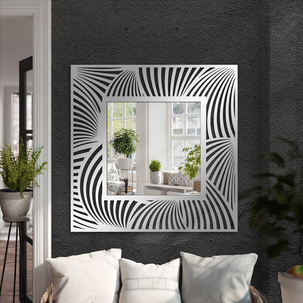 A framed wall mirror reflecting a bright room with plants is decorated with an abstract spiral pattern, creating a modern geometric focal point.
