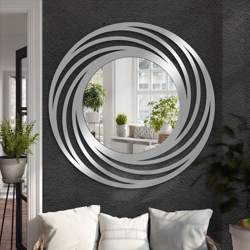 Negative space accentuates the swirling design of this stained glass wall mirror, where layered rings of metal artwork create a mesmerizing, modern circle floor mirror.