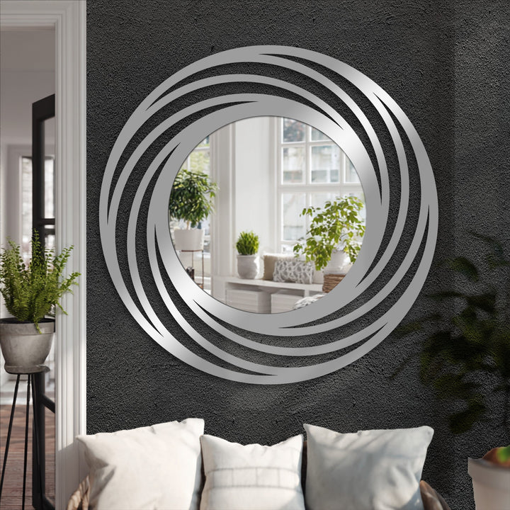 Negative space accentuates the swirling design of this stained glass wall mirror, where layered rings of metal artwork create a mesmerizing, modern circle floor mirror.
