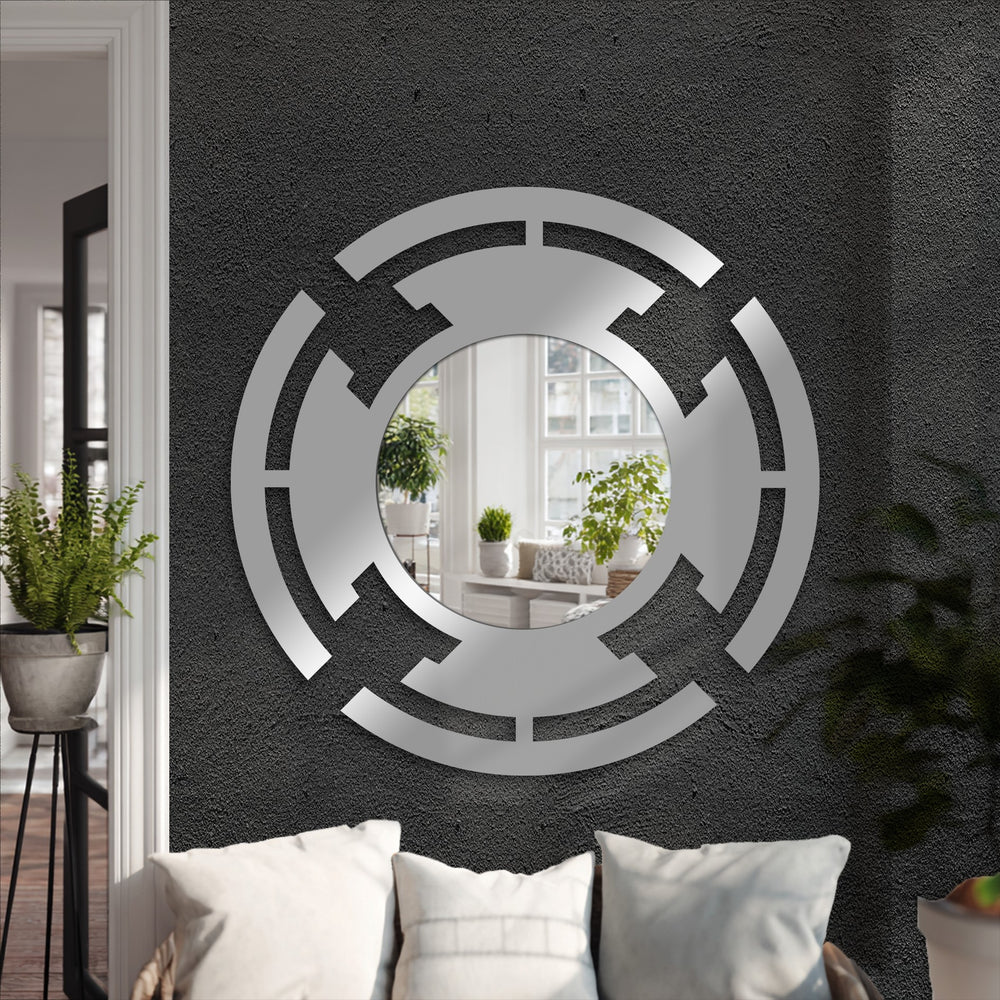 Sleek metal wall decor featuring a black finish complements the segmented ring circle decorative mirror with its modern geometric design.