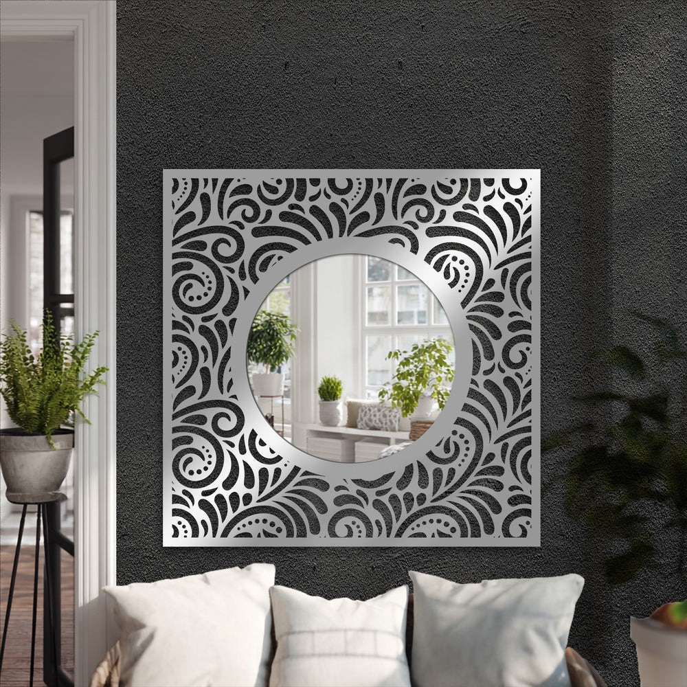 Reflecting a bright room, the ornate eclipse framed wall mirror showcases a black metal patterned square frame with a round center.