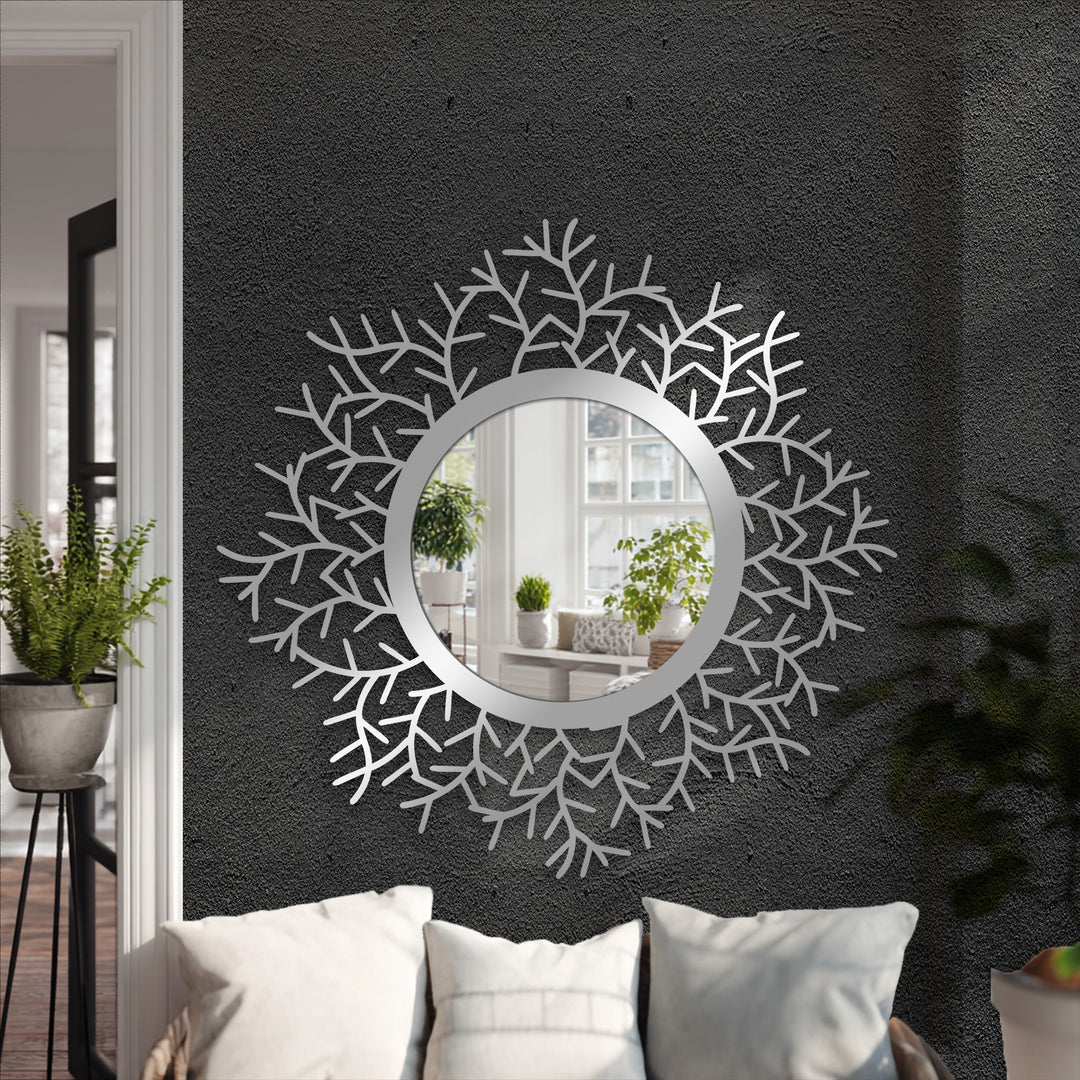 Botanical halo floor mirror featuring a striking metal artwork design that incorporates black metal leaf details around a central round mirror as the loudest element.