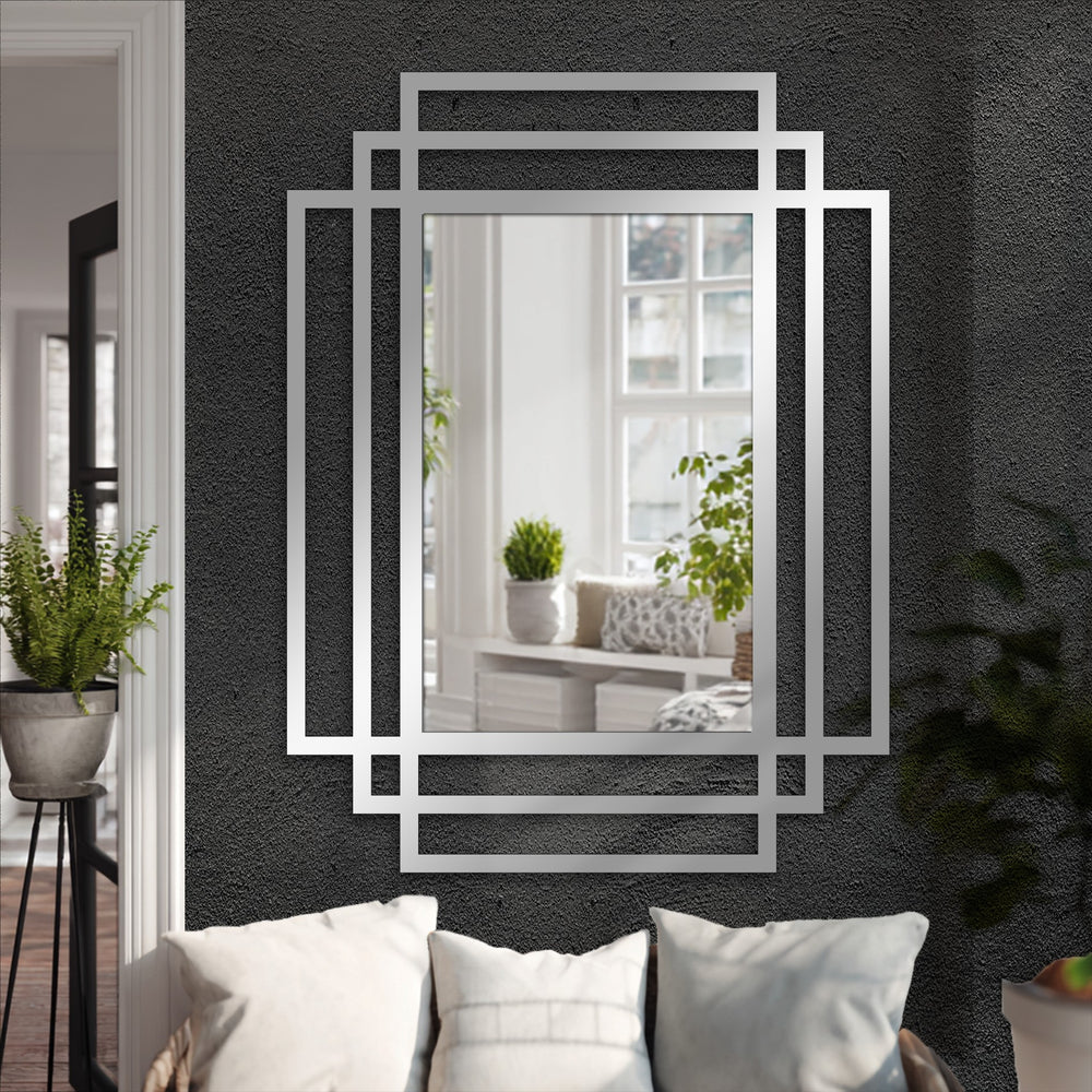Reflecting a bright interior, the layered rectangle frames mirror, with its modern black architectural design, demonstrates decorating with wall mirrors to enhance the focal point.