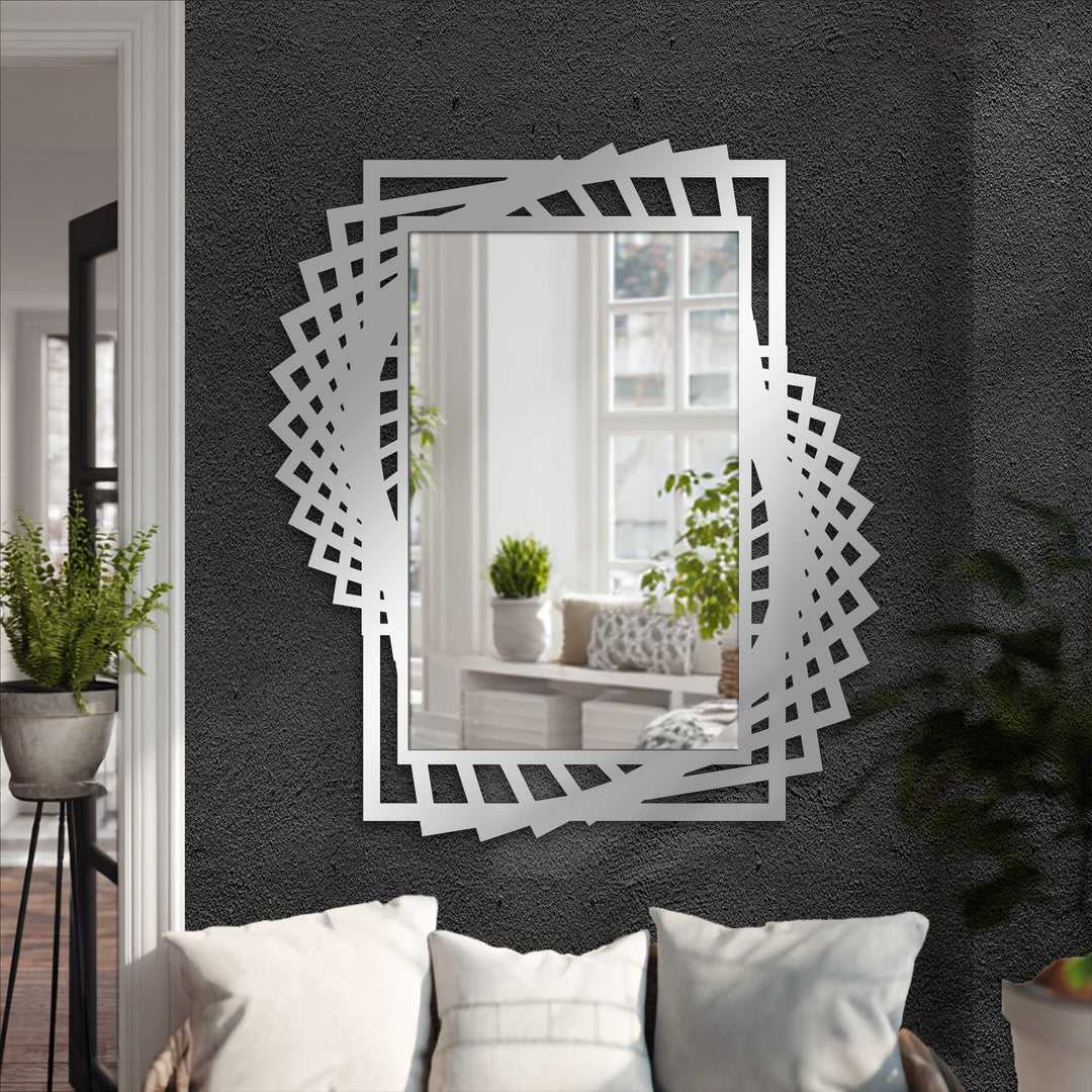 Silver-toned finish enhances the unique geometric design of this twist frame metal floor mirror, providing a subtle sheen characteristic of modern wall mirrors.