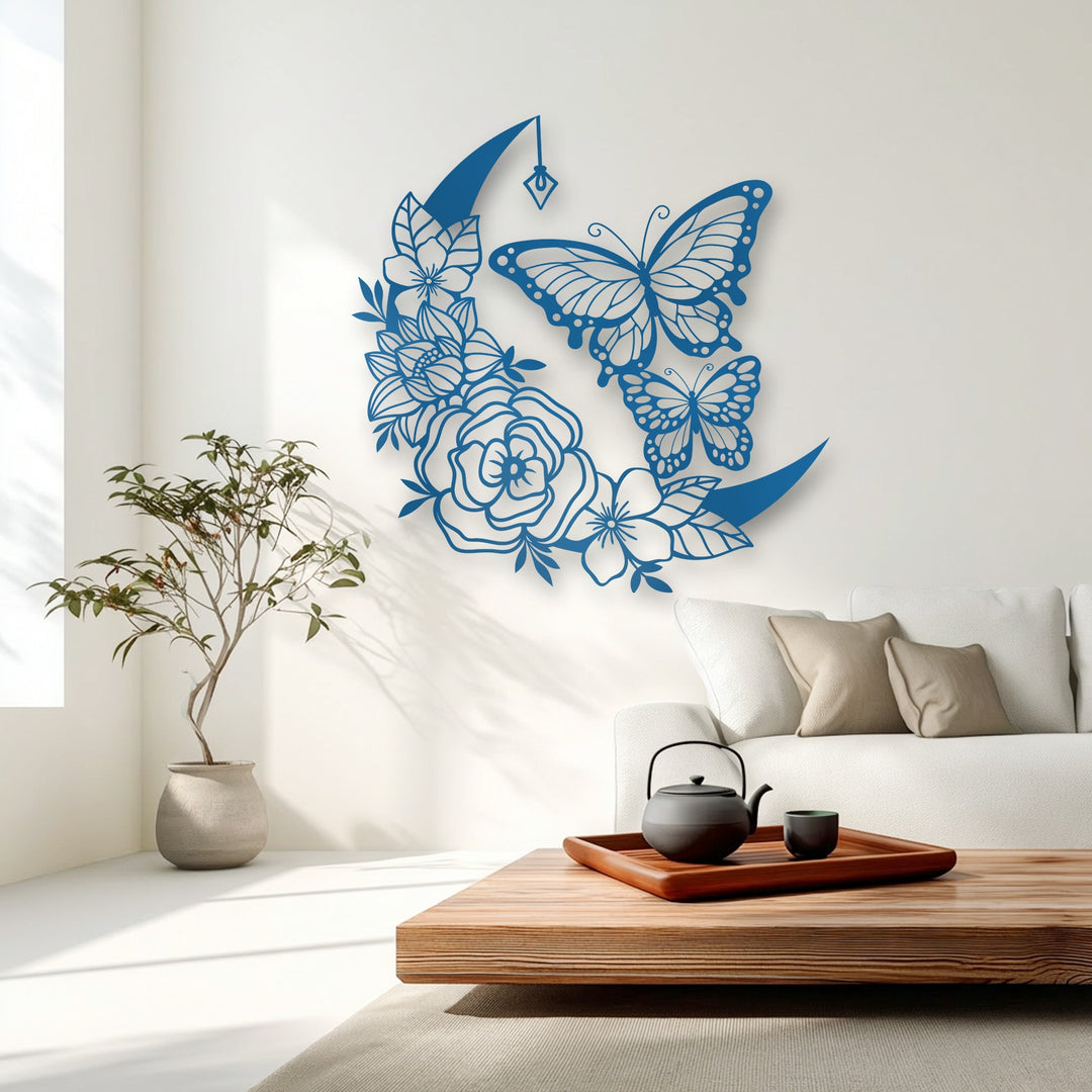 Delicate organic forms of a crescent moon and butterflies are intricately crafted into a serene floral metal artwork, gracing a bright room.
