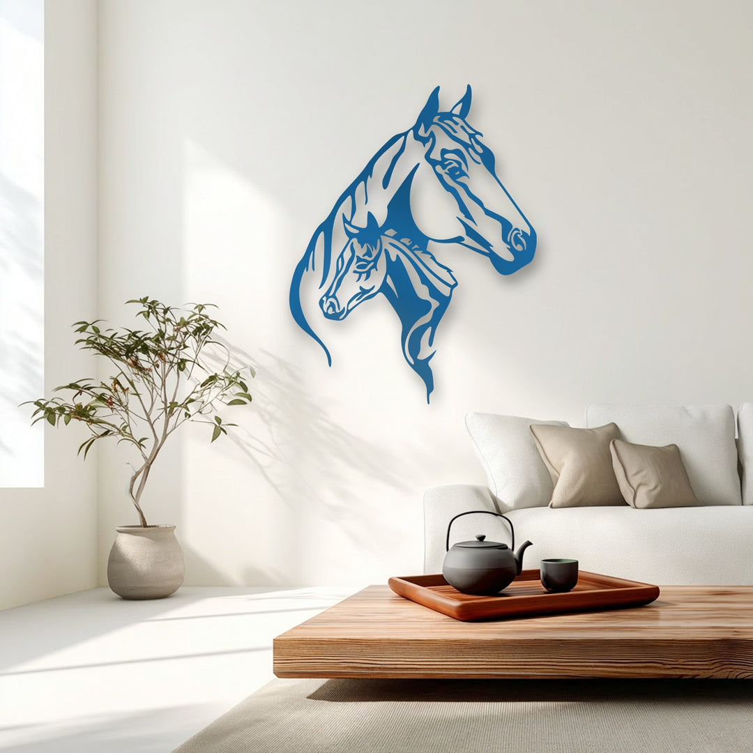 The precise, smooth edges of the unique metal wall art form a striking blue dual horse head silhouette, standing out against a white wall.