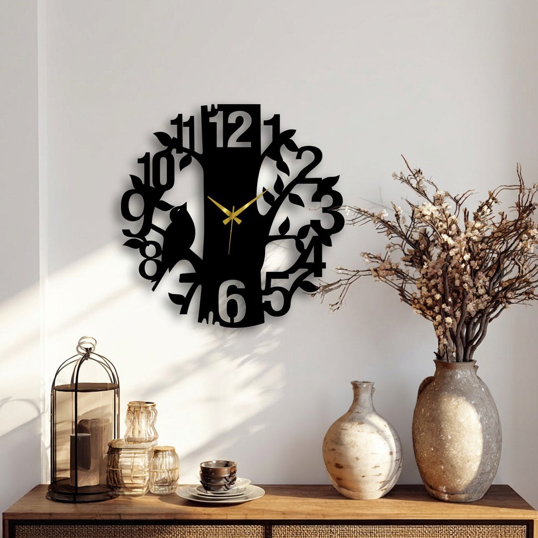 Minimal color saturation showcases the sleek, matte black of the nature-inspired tree and cat metal wall clock, a stylish piece of metal wall decor.
