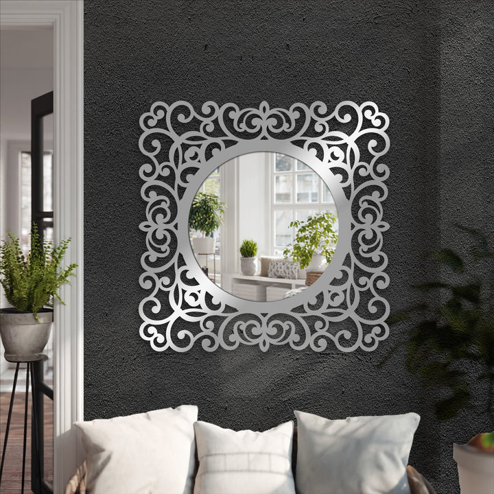 High color contrast highlights the baroque scroll frame's ornate decoration wall art against a dark wall in this round black metal mirror.