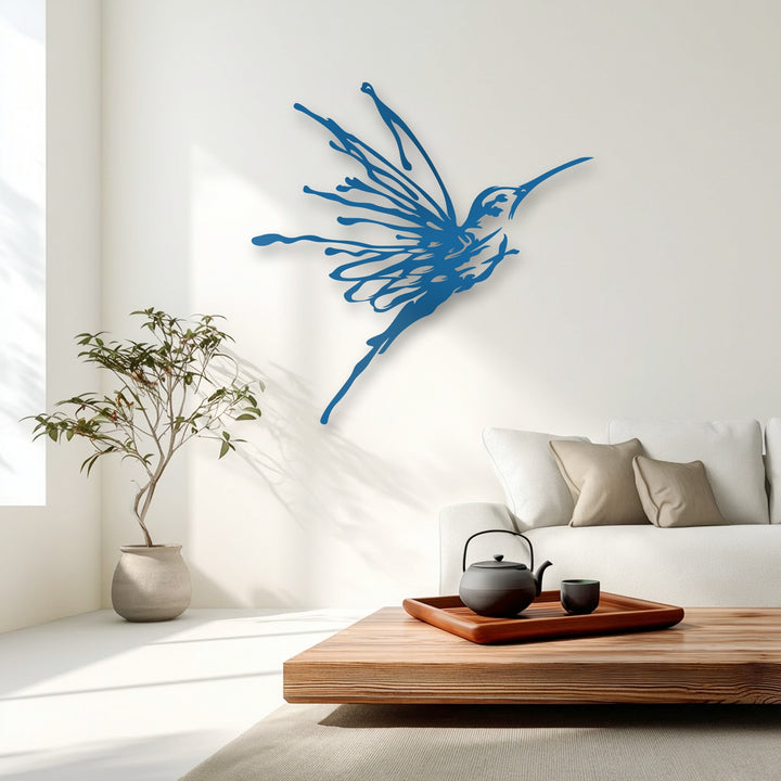 The finish of the blue flying hummingbird metal art for wall is sleek and matte, casting a subtle shadow on the bright white wall.