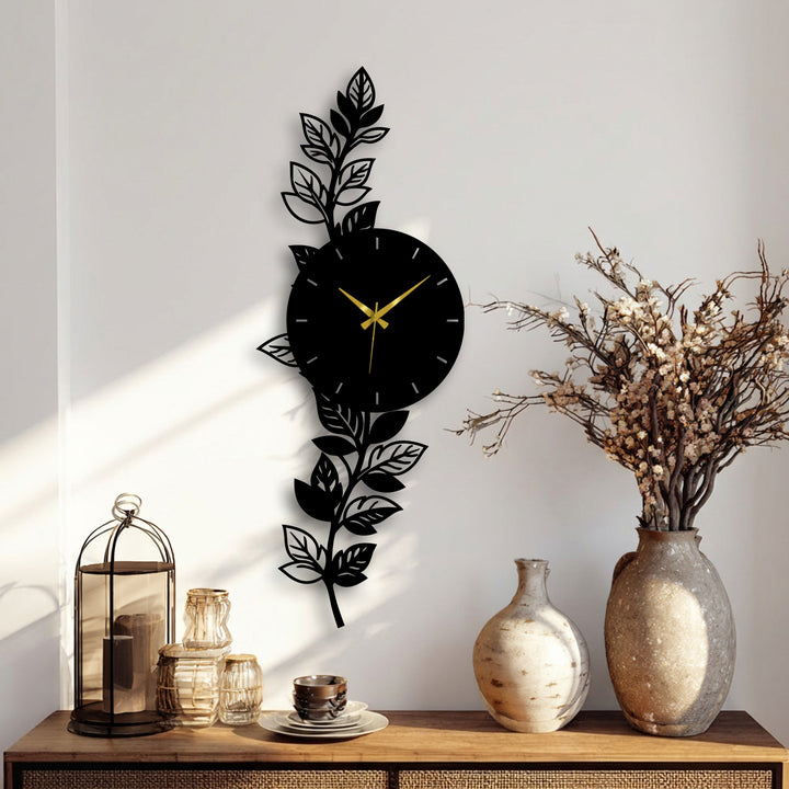 The darkest area of the botanical leaf metal wall clock artfully contrasts against the wall, highlighting the clock's elegant design as part of modern home decor.