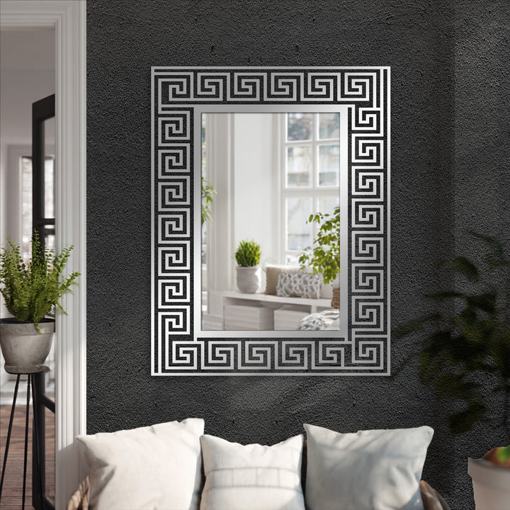 Reflecting a bright interior, the Greek key pattern metal frame around this full-length mirror adds a touch of decoration wall art to the black wall.