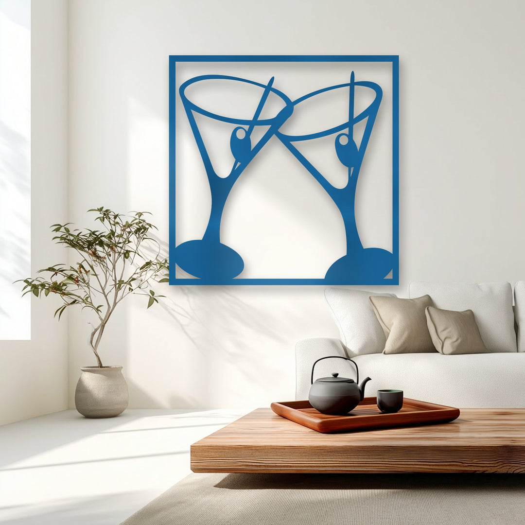 The matte royal blue finish of the decorative metal art showcases two modern, clinking martini glasses, perfect for bar decor.