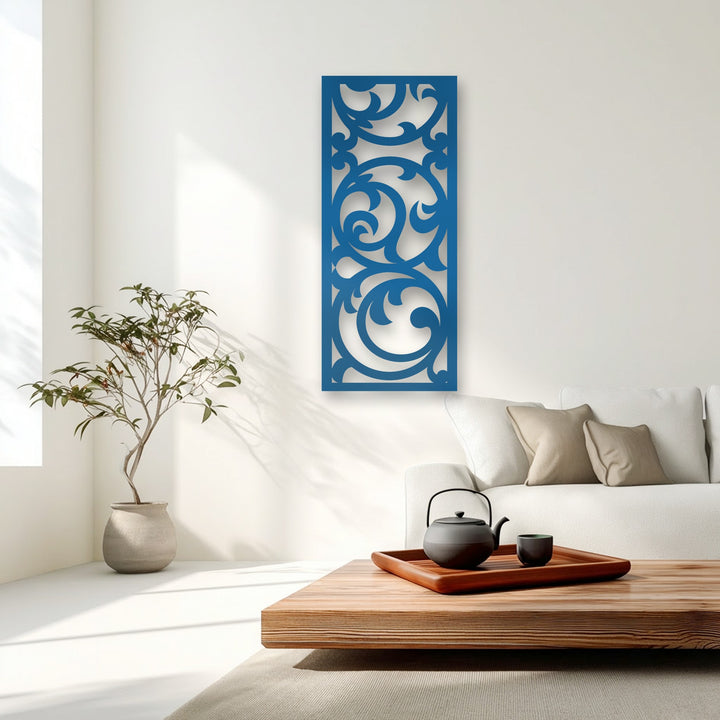 A vibrant transition of colors occurs as the striking blue unique metal wall art contrasts with the bright white wall, showcasing elegant floral scrolls.