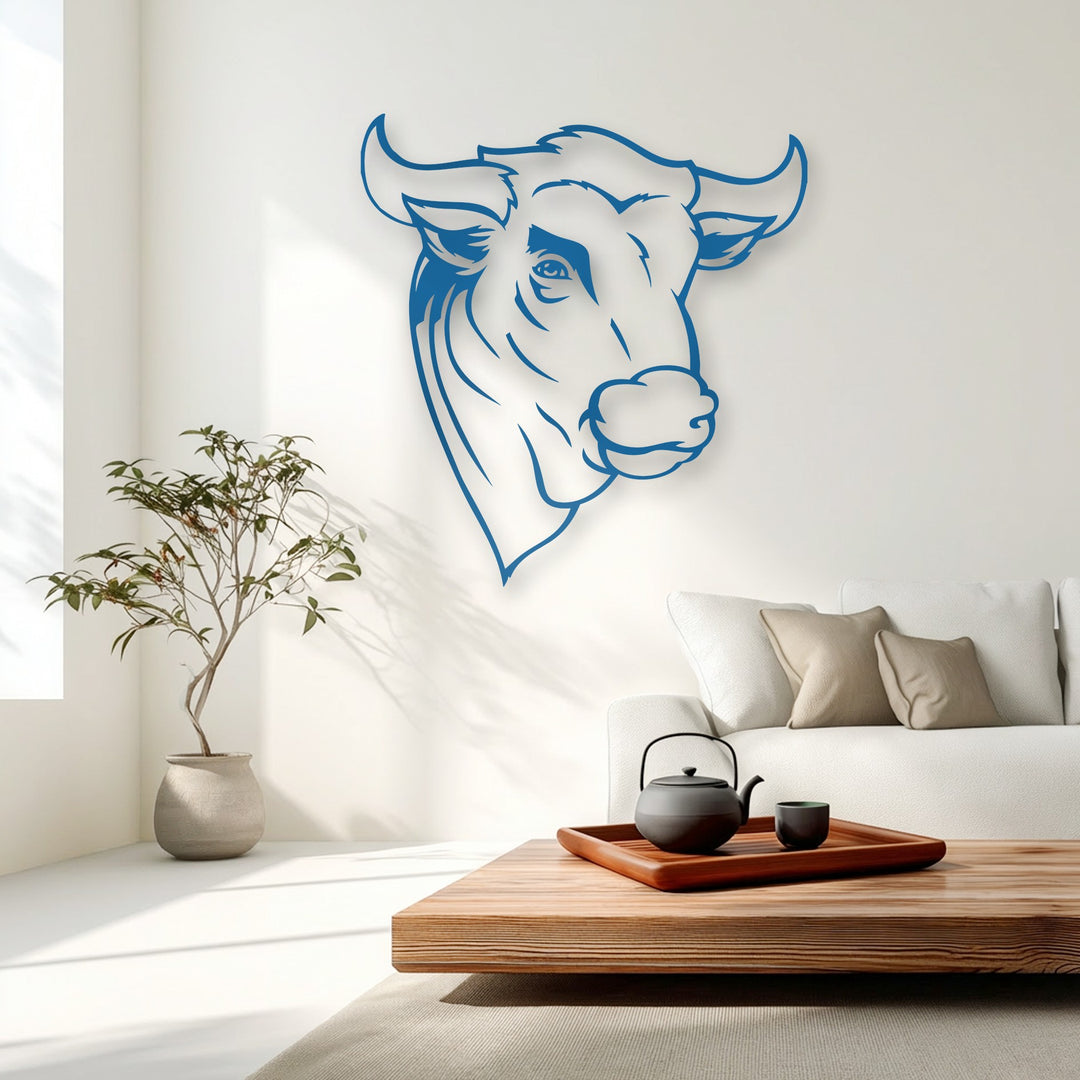 The stillness of a serene living space highlights a striking azure bull head metal wall decor, creating a calm focal point.