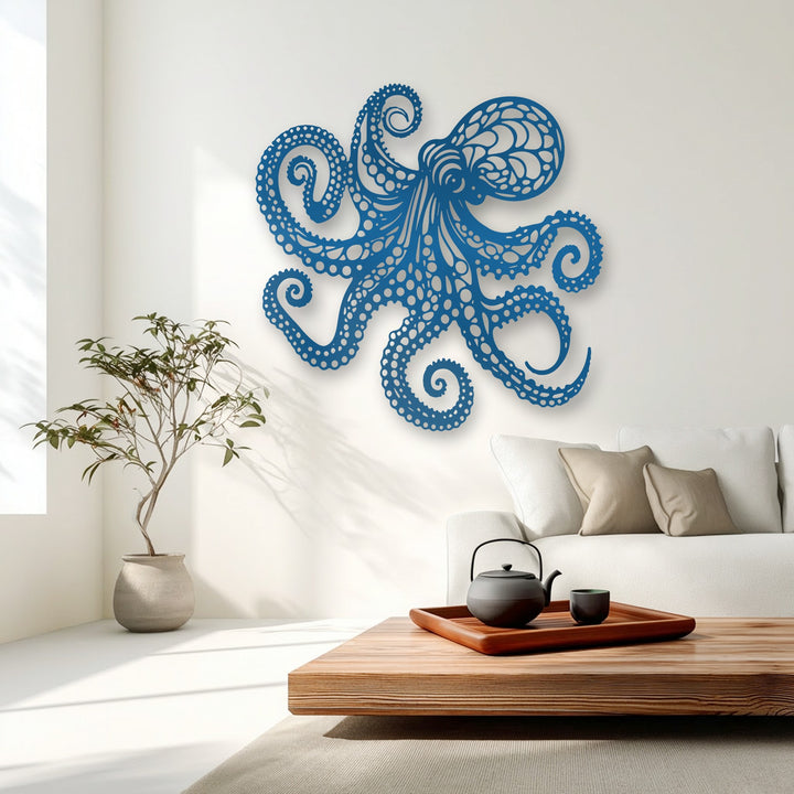 Dark black teapot on a wooden tray complements the vibrant blue octopus unique metal wall art, enhancing the room's nautical ocean decor.