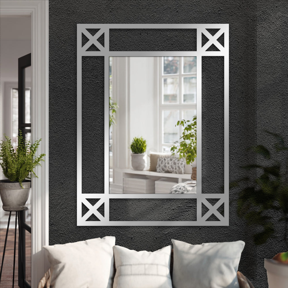 The focal point shows a minimalist cross detail black metal floor mirror adding elegance to decorating with wall mirrors, displayed against a textured wall.