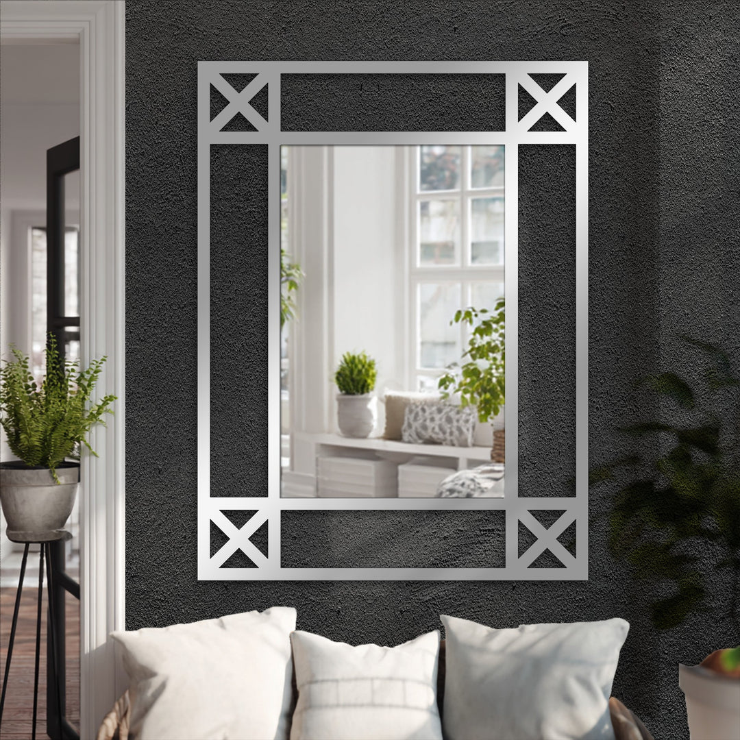 The focal point shows a minimalist cross detail black metal floor mirror adding elegance to decorating with wall mirrors, displayed against a textured wall.