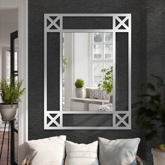 The focal point shows a minimalist cross detail black metal floor mirror adding elegance to decorating with wall mirrors, displayed against a textured wall.