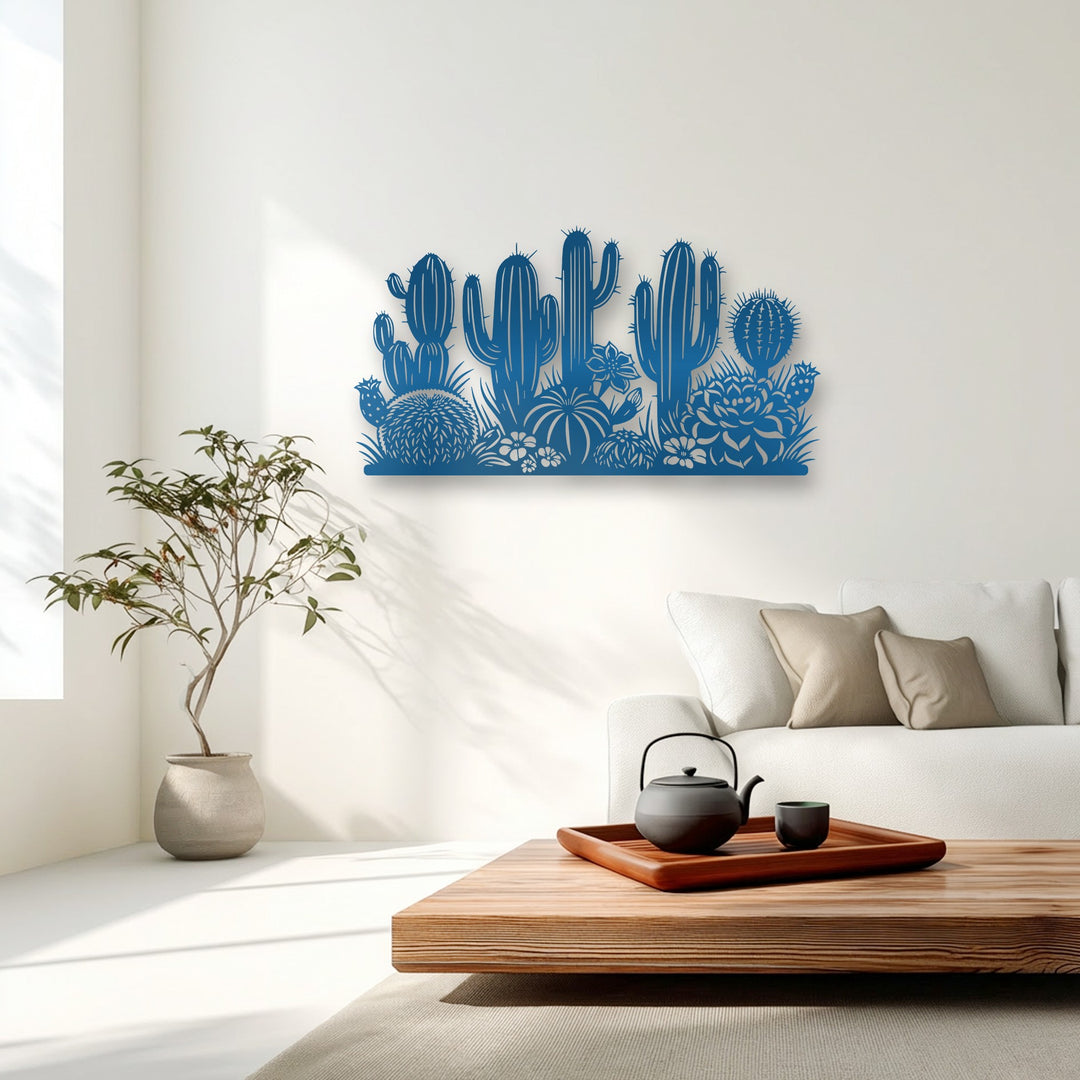 Shifting light subtly animates the deep blue desert cactus garden metal artwork, creating a flowing botanical silhouette that feels alive.